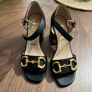 Gucci Black Heels with Gold Accents
Worn once